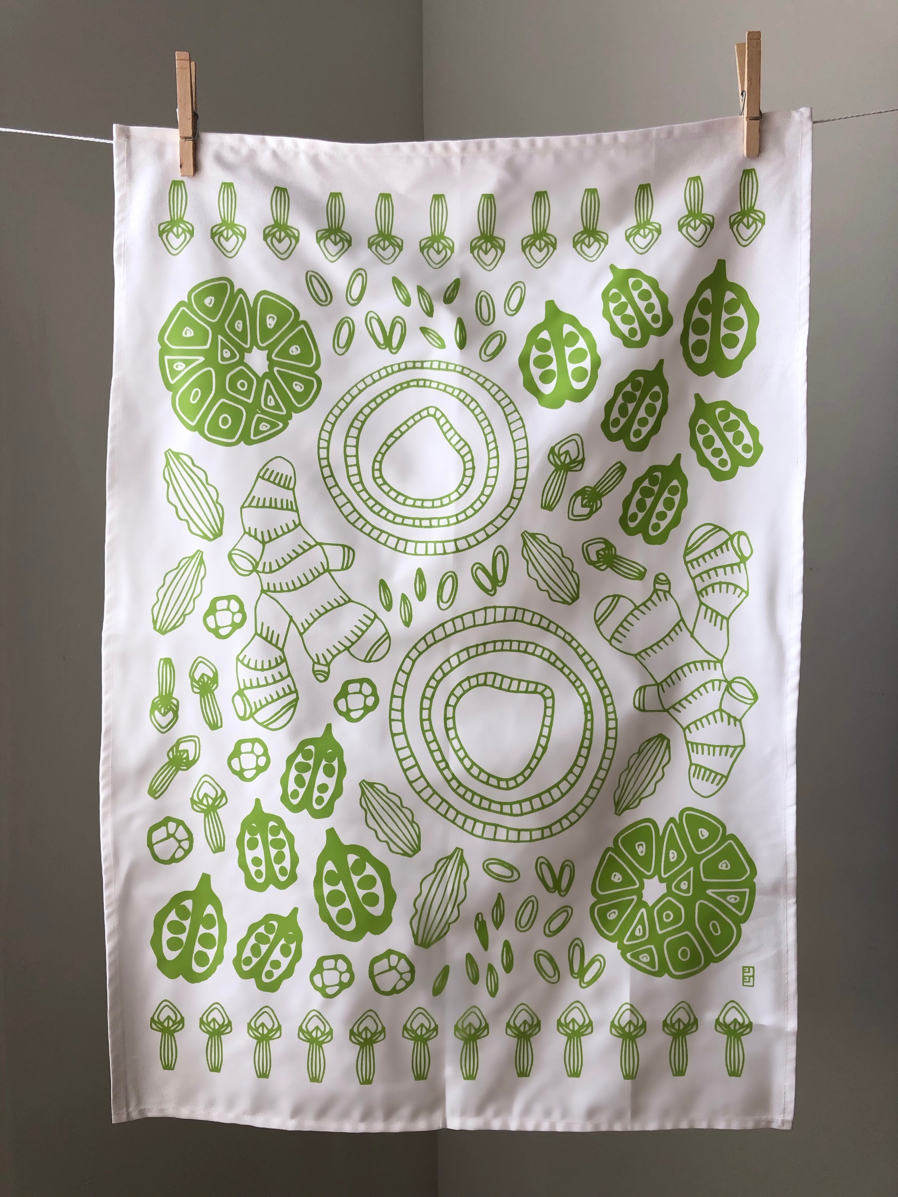 Display of tea towel with vegetable print.