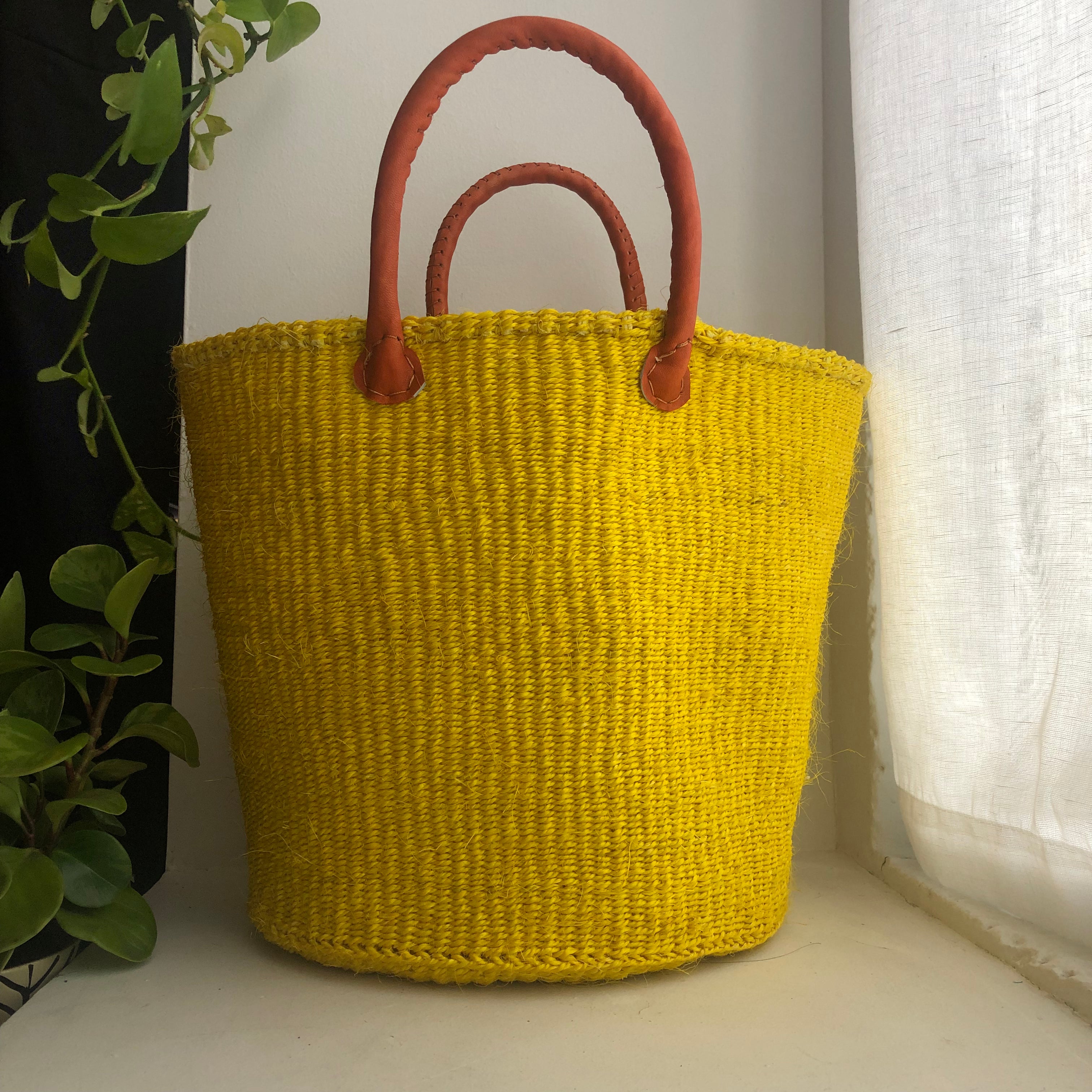 yellow basket with leather handles