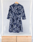 Display of navy dress with white floral print.