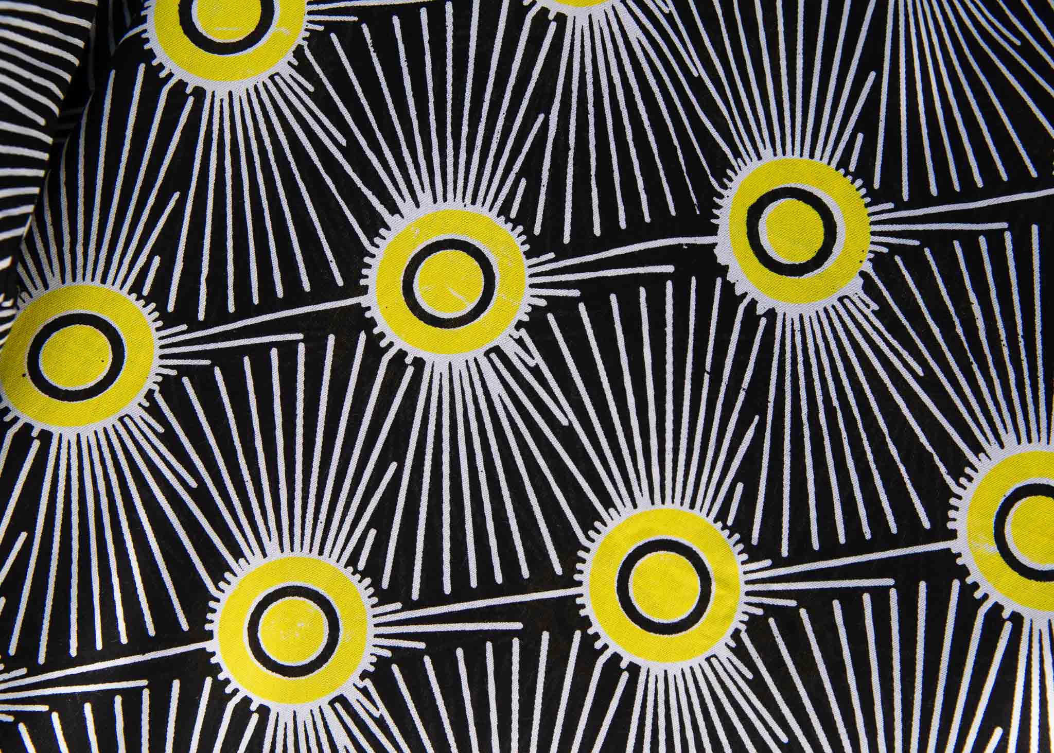 Display of black and white dress with yellow burst print.