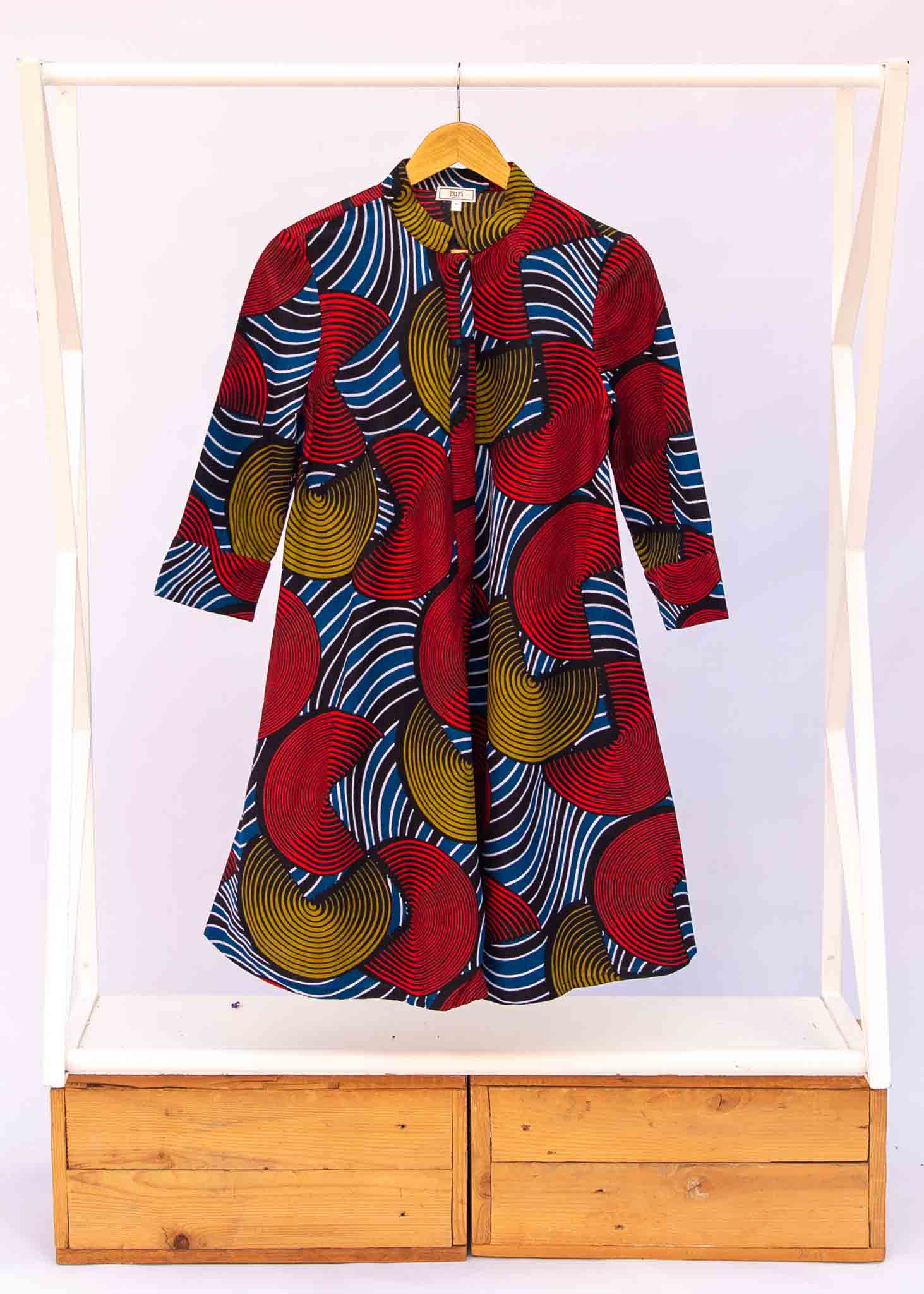 Display of circle design dress, featuring primary colors.