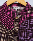 detail of a pink, purple, black and white shirt dress
