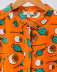 display of an orange, white and green plant design dress