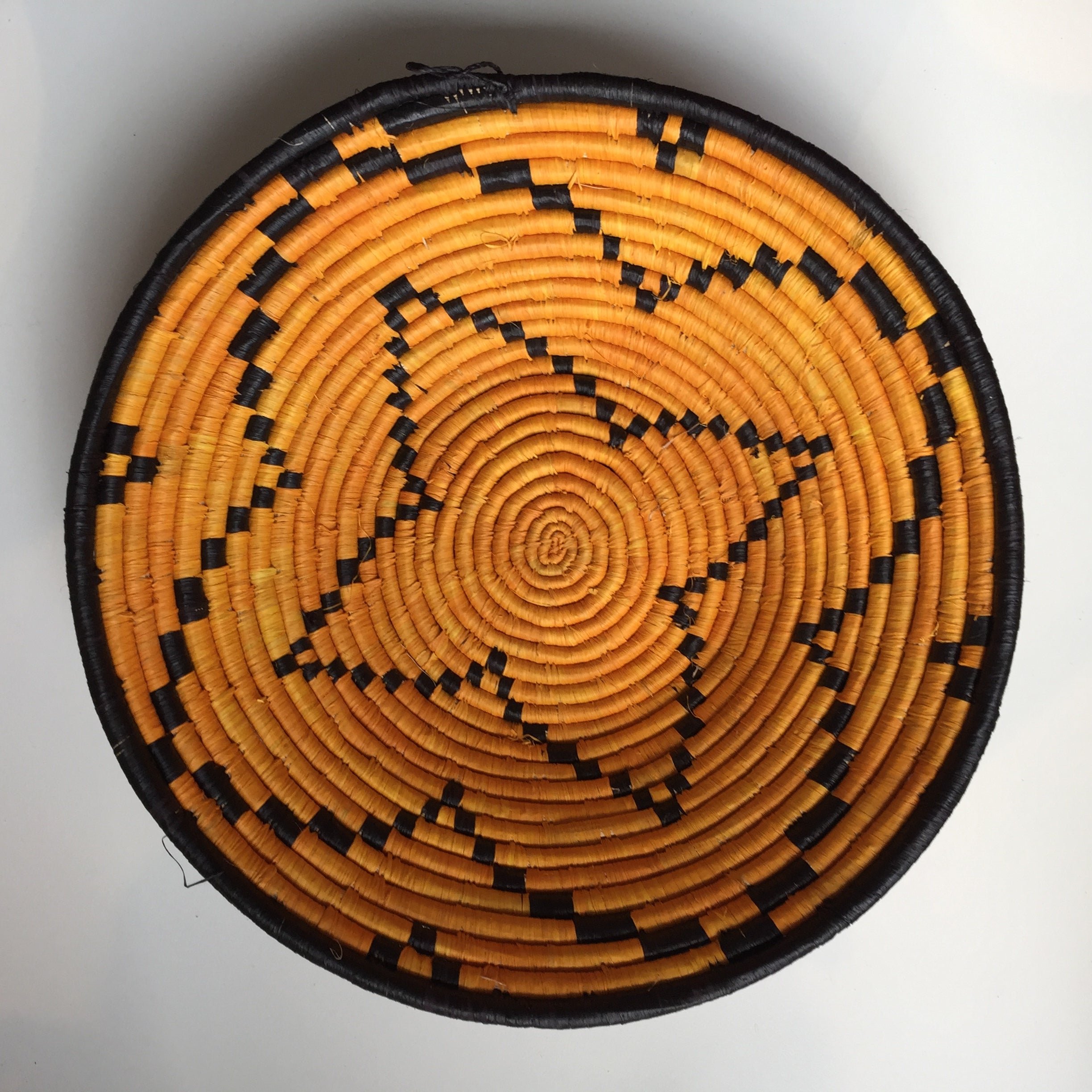 Orange and black flower design woven bowl