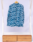 Display of blue, white domino print shirt.