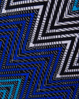 Close up display of blue, aqua and white zig zag print dress, fabric.