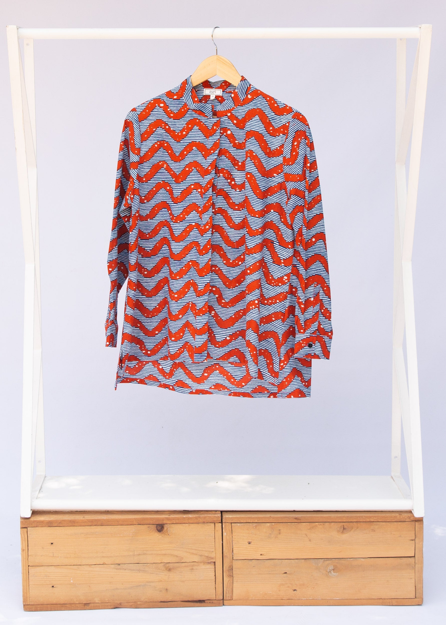 Display of blue and red zigzag print blouse.