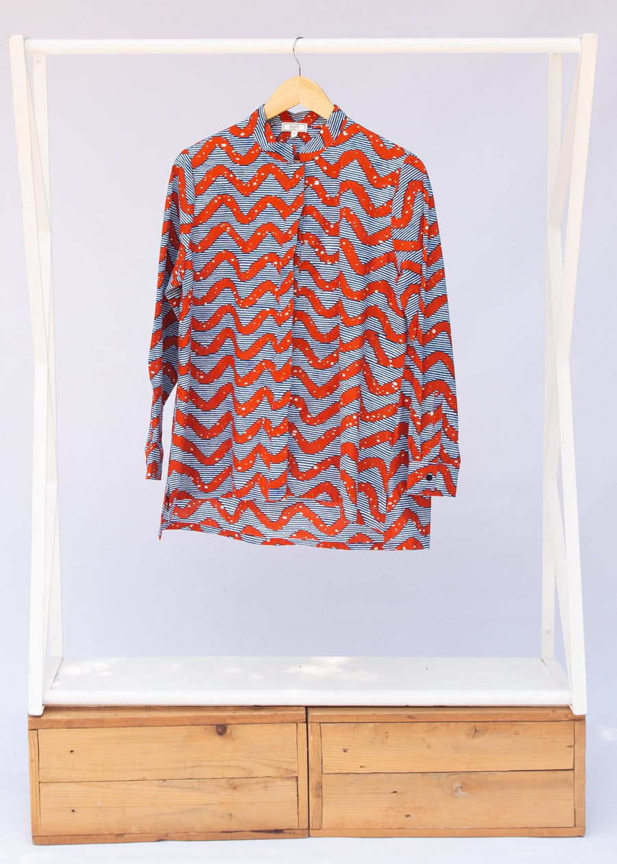 Display of blue and red zigzag print blouse.