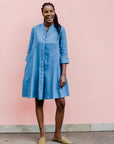 Model wearing a cerulean blue linen dress.